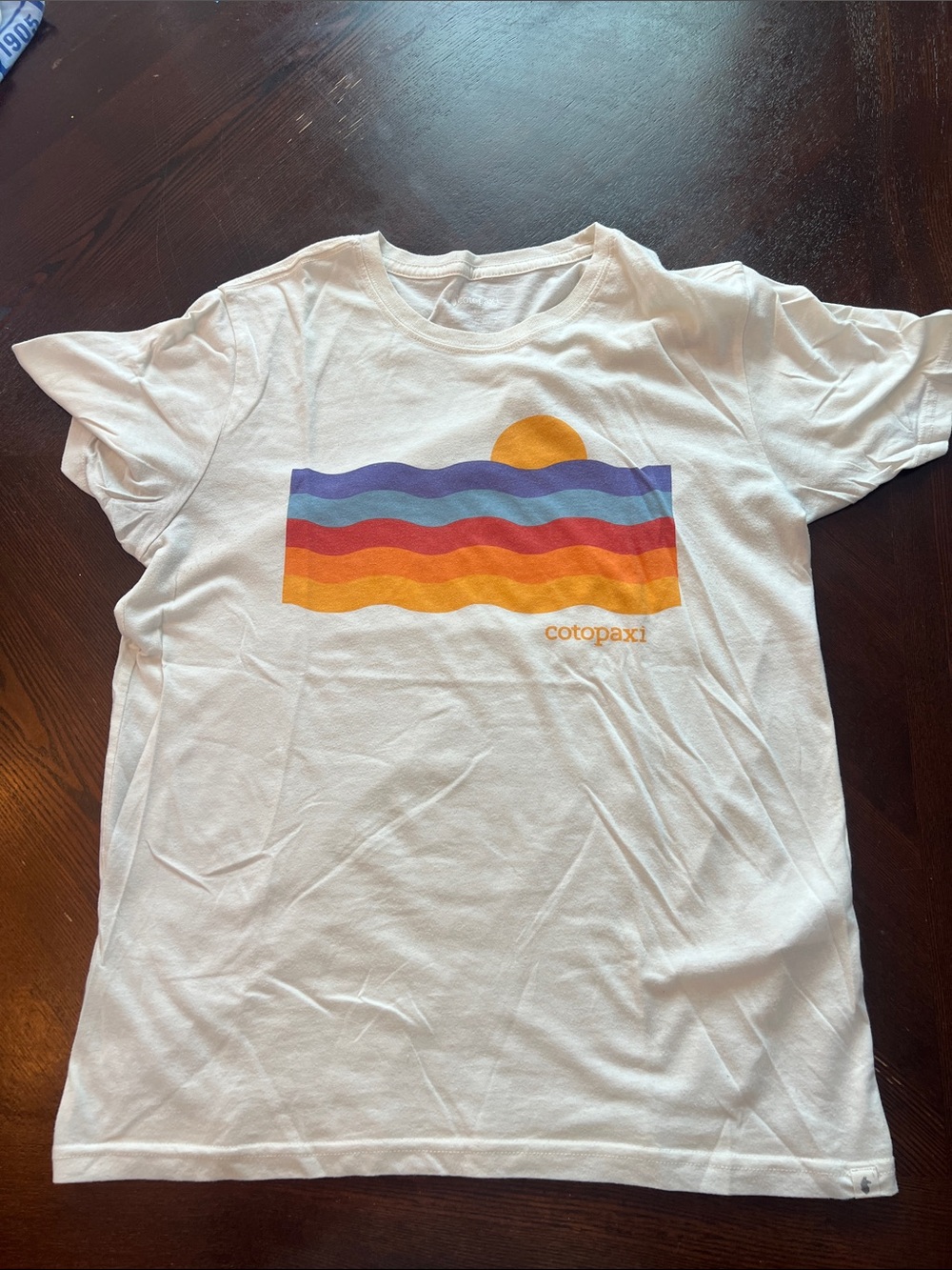 cotopaxi White Short-Sleeve Tee with Blue, Purple, Red and Orange Wave Graphic